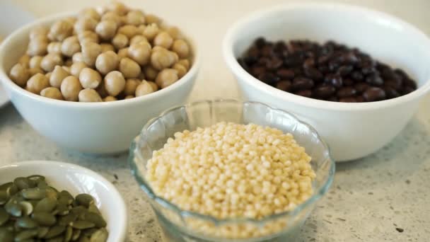 Various Legumes Seeds Grains Bowls White Bench Pan Close — 비디오