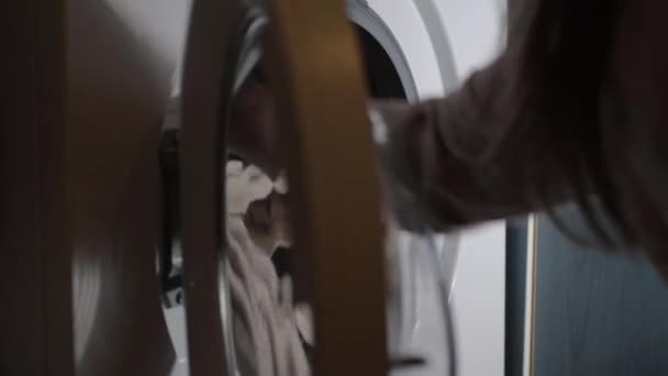 Hand Loading Washing Machine Clothes Closing Door — Video