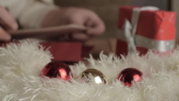 Soft Focus Hand Writing Out Christmas Greeting Cards Baubles — Stockvideo