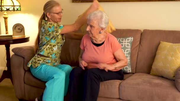 Home Healthcare Nurse Making Her Elderly Woman Patient Comfortable Couch — стоковое видео