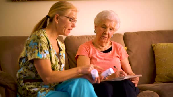 Closeup Home Healthcare Nurse Going Medications Elderly Woman While Sitting — Stockvideo