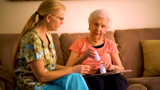 Closeup Home Healthcare Nurse Going Medications Elderly Woman While Sitting — Vídeo de Stock