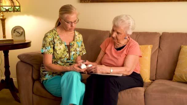 Home Healthcare Nurse Going Medications Elderly Woman While Sitting Living — Vídeo de Stock