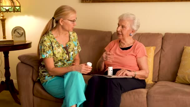 Home Healthcare Nurse Going Medications Elderly Woman While Sitting Living — Vídeo de Stock