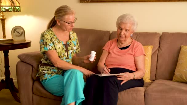 Home Healthcare Nurse Going Medications Elderly Woman While Sitting Living — Stockvideo