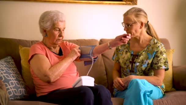 Home Healthcare Nurse Elderly Woman Taking Blood Pressure Monitor — Stock video