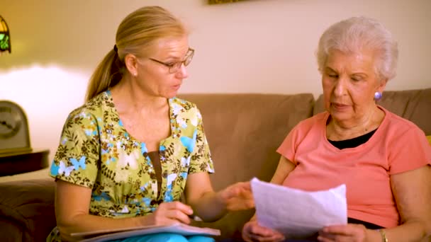 Front View Closeup Elderly Woman Home Healthcare Nurse Going Paperwork — 图库视频影像