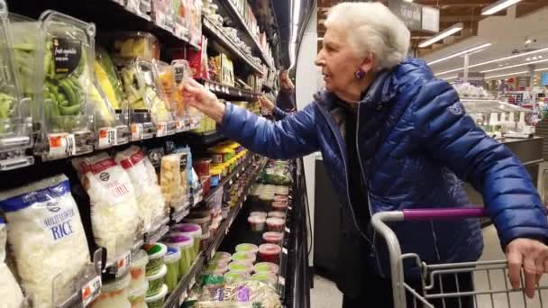 Elderly Woman Looking Cut Squash Plastic Container Grocery Store — Stock videók