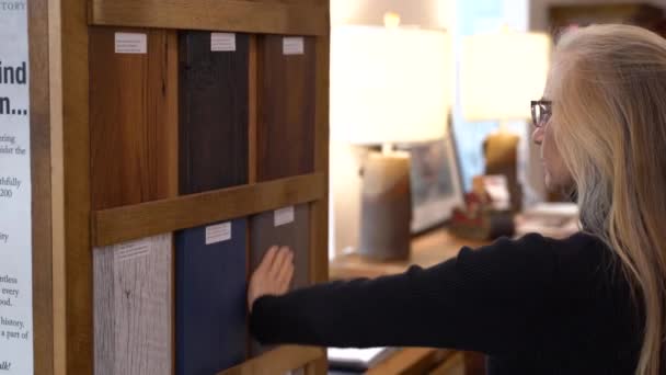 Pretty Mature Woman Looking Touching Furniture Finish Samples Furniture Store — Stock videók