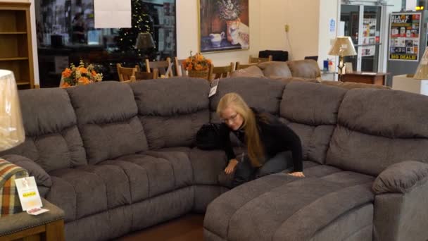 Pretty Mature Blonde Woman Getting Comfortable Couch Furniture Showroom Christmas — Vídeo de Stock