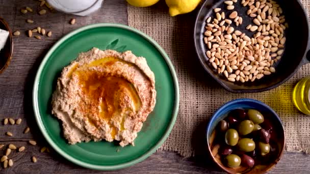 Wide Sliding Left Showing Flat Lay Plate Hummus Feta Olives — Stockvideo