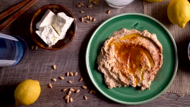 Wide Sliding Right Showing Flat Lay Plate Hummus Feta Olives — 图库视频影像