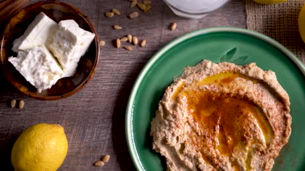 Sliding Right Showing Flat Lay Plate Hummus Feta Olives Glass — Vídeo de Stock