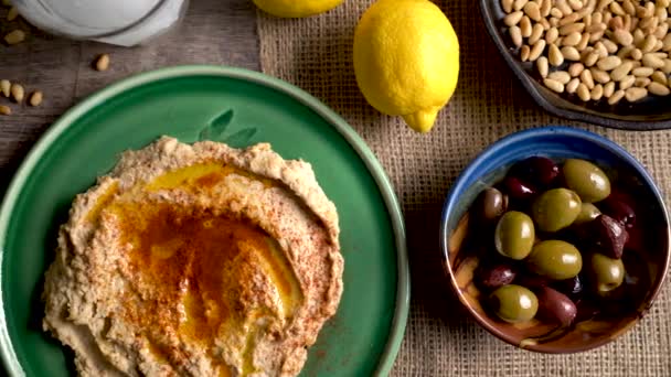 Sliding Left Showing Flat Lay Plate Hummus Feta Olives Glass — Stockvideo