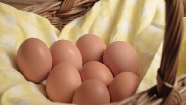 Hand Getting Fresh Brown Eggs Out Woven Basket — Stockvideo