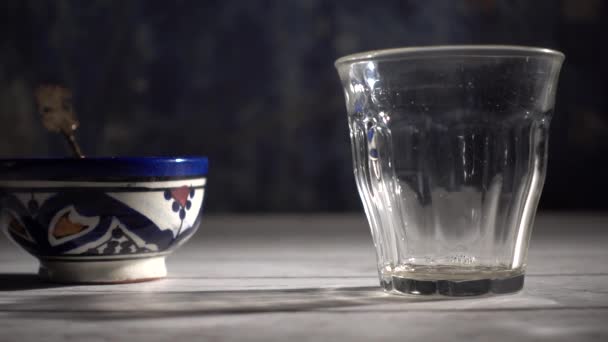 Slow Motion Extreme Closeup Tea Pouring Glass Dark Blue Background — 비디오