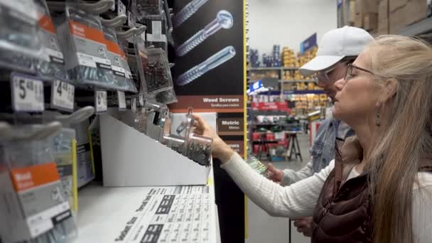 Closeup Mature Woman Handsome Man Looking Screws Hardware Store — Vídeo de Stock