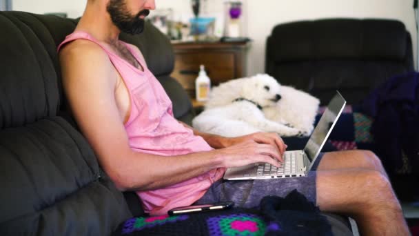 Bearded Caucasian Man Home Sofa Typing Notebook Phone Side Medium — Stockvideo