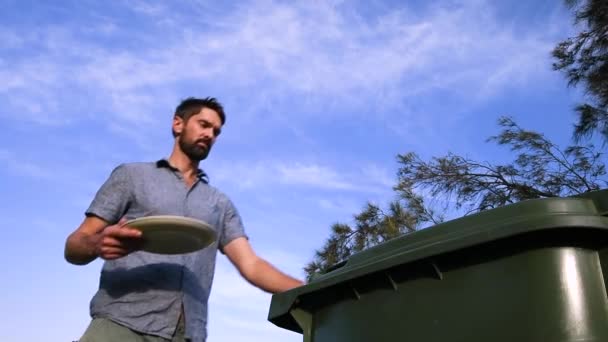 Man Wastes Plate Food Discarding Bin Low Angle Shot — Stockvideo