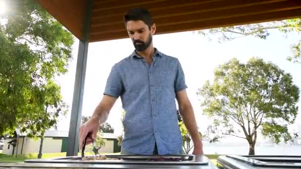 Bearded Man Cooks Vegan Food Hot Plate Park Fixed Wide — Stok Video