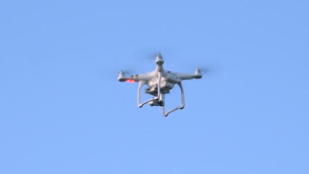 White Quadcopter Drone Hovering Spinning Mid Air Close — Vídeos de Stock