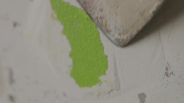 Steady Close Shot Man Struggling Scrape Green Paint Wall — Stockvideo