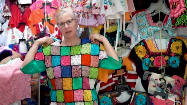 Mature Woman Holds Colorful Mexican Crocheted Blouse Asks You Smiles — Stockvideo