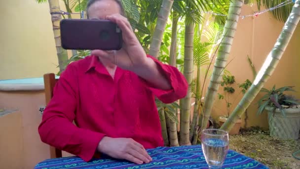 Closeup Mature Man Wearing Guayabera Shirt Takes Selfie Garden Table — 图库视频影像