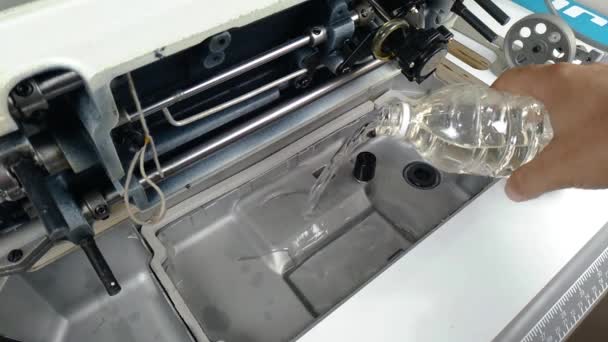 Closeup Tailor Hands Pour Oil Bottle Sewing Machine Static — Video