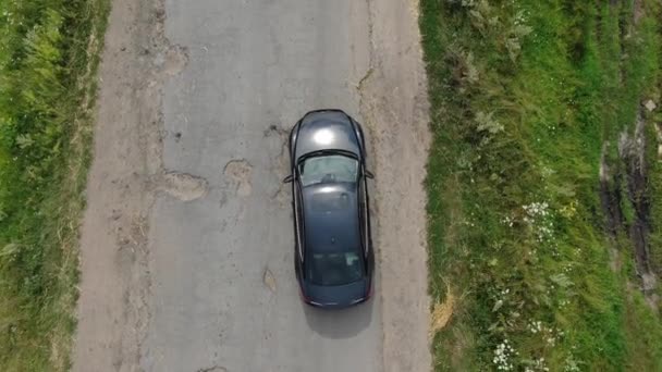 Aerial View Car Avoiding Potholes Old Road — Stockvideo