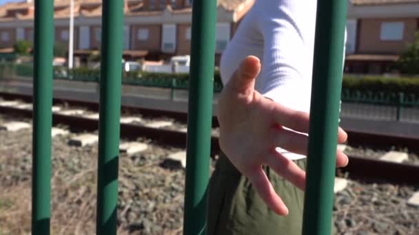 Girl Walking Sliding Her Hand Railing Background Houses Train Track — Stockvideo