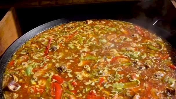 Spanish Paella Boils Large Saucer Pan Wide Shot Moving Close — Stockvideo