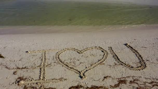 Love Written Sand Water Laps Beach — Vídeos de Stock