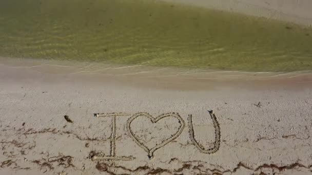 Love Written Sand Water Laps Beach — Stockvideo