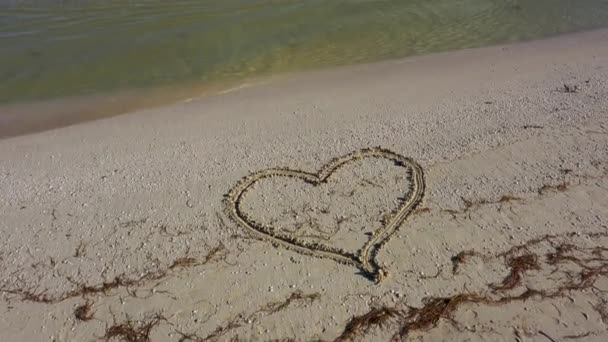 Camera Tilts Love Written Sand Beach Horizon Showing Ocean — стоковое видео