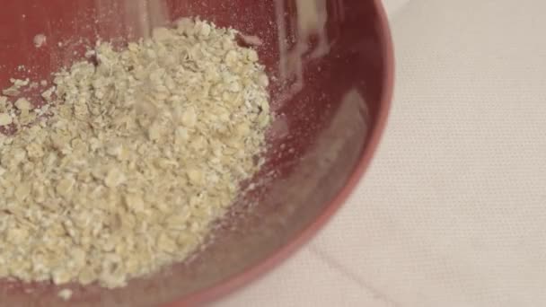 Helping Dry Rolled Oats Pouring Red Bowl — Videoclip de stoc
