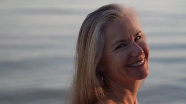 Beautiful Mature Blonde Woman Looks Setting Sun Turns Look Camera — стоковое видео