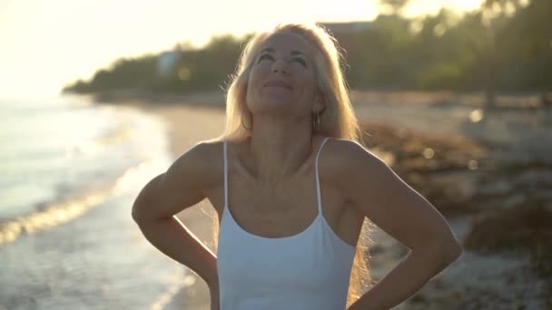 Slow Motion Backlit Mature Woman Hands Her Hips Smiling Flirting — Vídeos de Stock
