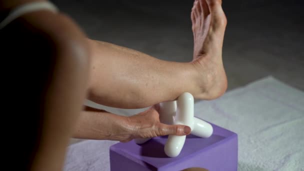 Mature Woman Uses Massage Tool Stretching Calf Muscles — Vídeo de Stock