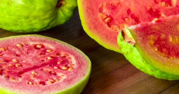 Closeup Sliced Red Guavas Wooden Background — Stockvideo