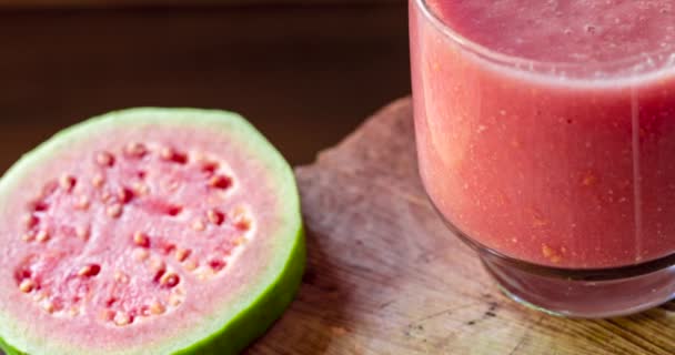 Glass Red Guava Juice Sliced Guava Slice Wooden Background — Stockvideo