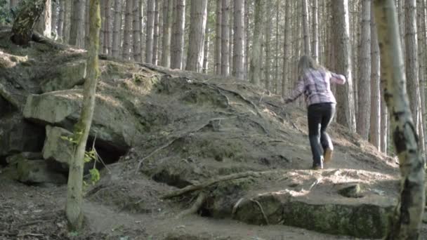 Woman Climbing Hill Pine Forest Wide Shot — Stockvideo