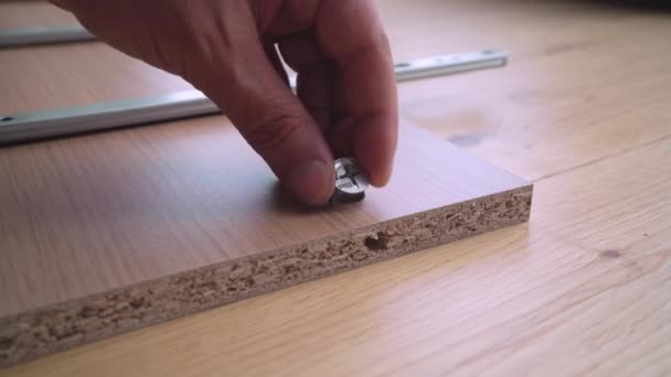 Handyman Assembling Cam Lock Wooden Furniture Sled Rails — Video Stock