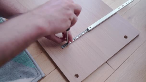 Man Installing Drawer Slides Element Chest Drawers Screwdriver Tests Ground — 图库视频影像