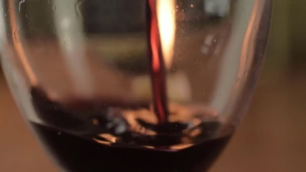 Pouring Red Wine Glass Warm Candle Background Close — Stock Video