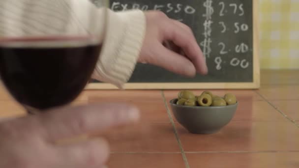 Manos Sosteniendo Copa Vino Tinto Comiendo Aceitunas Verdes Cafetería — Vídeos de Stock