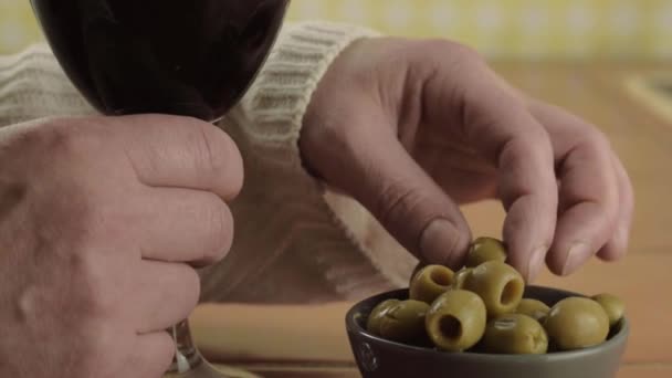 Hands Holding Glass Red Wine Eating Green Olives Close Shot — Vídeos de Stock