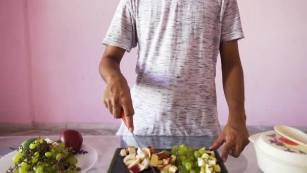 Young Man Making Fruit Salad Man Holding Knife Chopping Board — Video