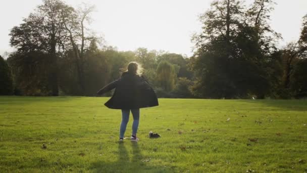 Young Caucasian Woman Happy Smiling Twirling Alone Circle Green Grass — Stockvideo