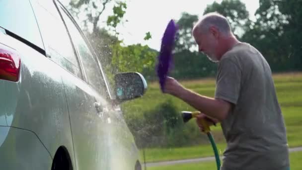 Slow Motion Man Washing His Car Dancing Hose Soapy Rag — Stockvideo